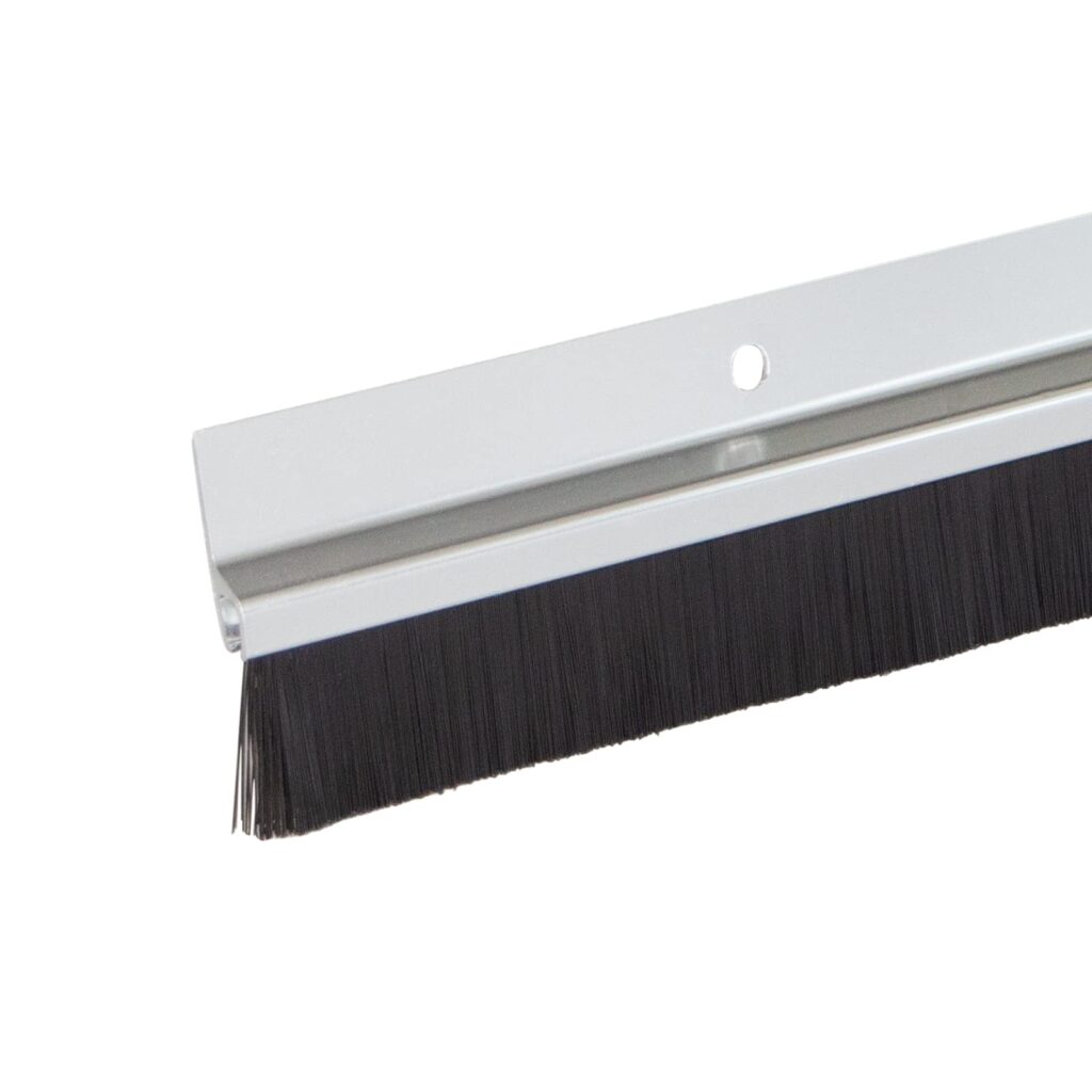 Industrial brush seal on metal strip, preventing dust and drafts with durable synthetic bristles.