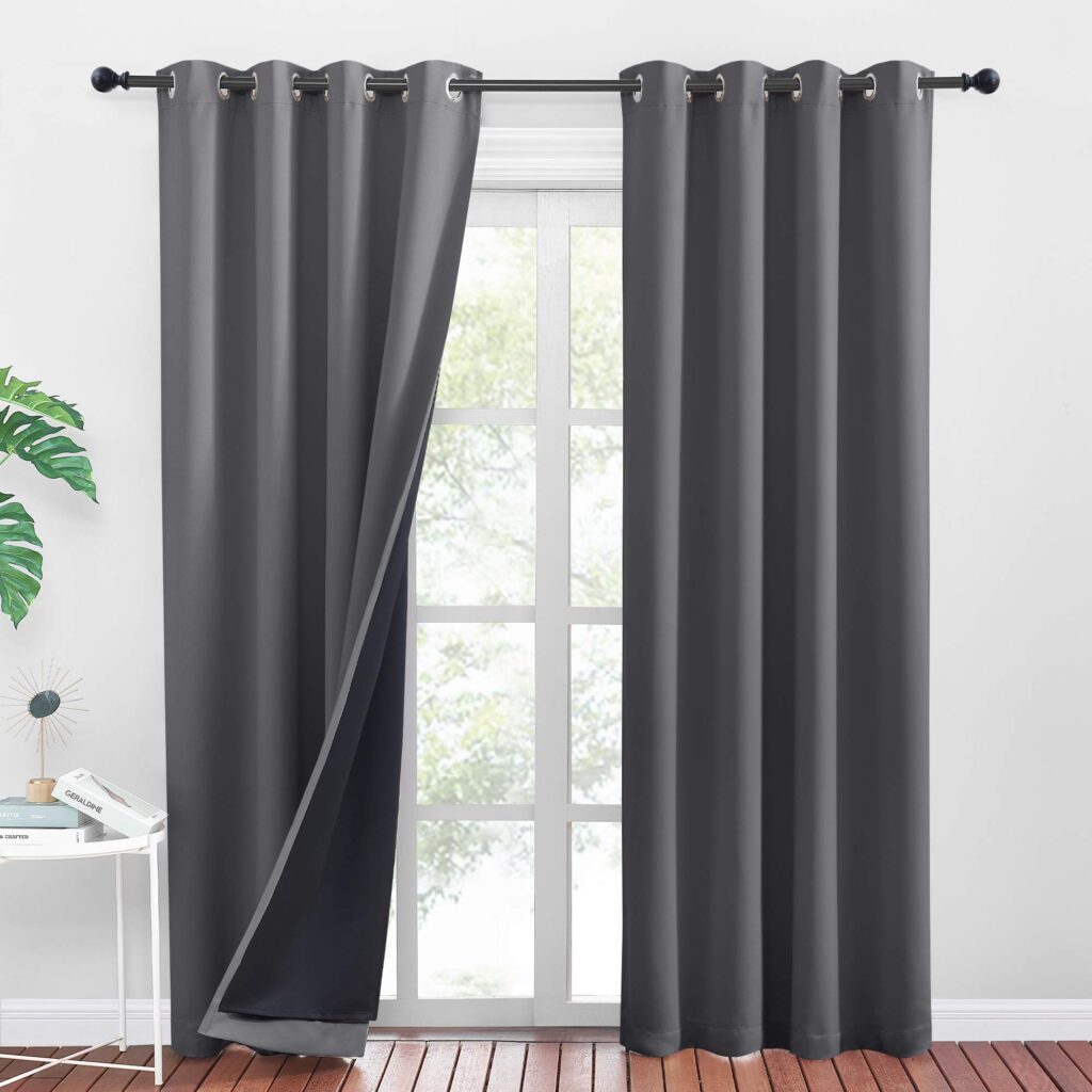 Dark gray blackout curtains in modern minimalist living room with wooden floor.