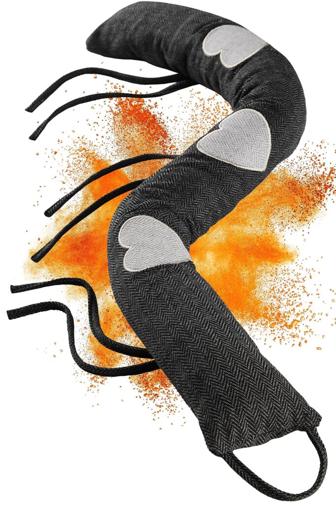 Intricate gray fabric with heart patches, black cords, and vibrant orange burst background.
